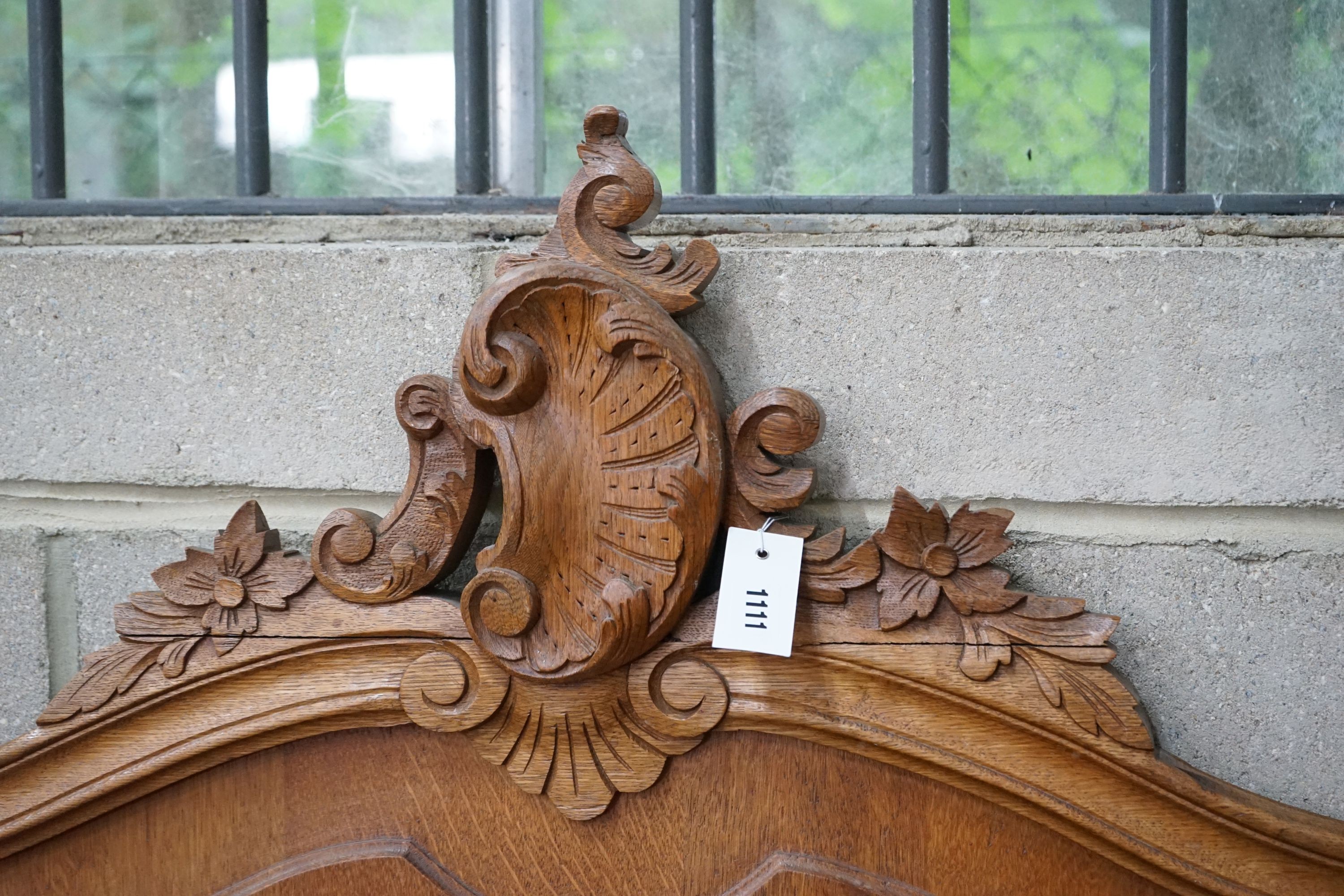 An early 20th century French carved oak double bedframe, width 136cm, headboard height 160cm